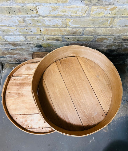 Vintage wooden cheese wheel storage box.